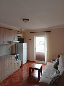 a living room with a couch and a kitchen at FAFALIOS Studios in Vrontádos +29 photos