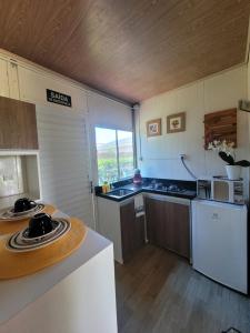 a kitchen with a sink and a counter top at Flat Vista Mar Noronha in Fernando de Noronha