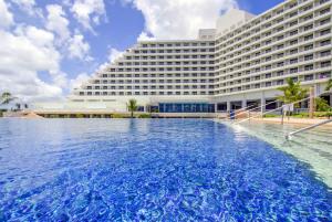 a hotel with a large pool in front of a building at RIHGA Royal Laguna Guam Resort in Tamuning