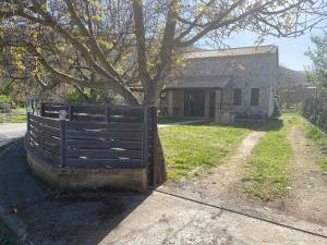 a black fence in front of a house at Poliani Village in Poliána