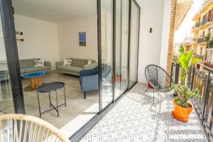 a living room with a couch and chairs on a balcony at CAN MARTINEZ Calella Beach Boutique Apartment in Calella