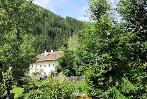 a white house in the middle of trees at FP Muehlmann&Schoen in Innervillgraten