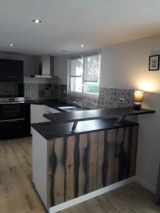a kitchen with a black counter top in a room at Auberge de Keringar in Le Conquet
