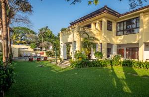 an exterior view of a house with a yard at Amritara The Poovath Beachfront Heritage, Fort Kochi in Cochin