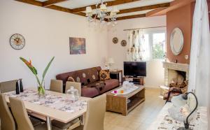 a living room with a table and a couch at Meliti Villa in Argostoli