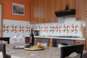 a table with a bottle of wine and two wine glasses at Apartment Gaja in Tolmin