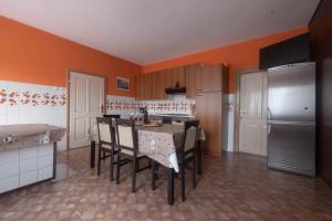 a kitchen with a table with chairs and a refrigerator at Apartment Gaja in Tolmin