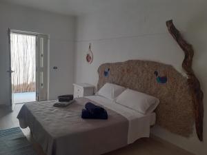 a bedroom with a large bed with a large headboard at bed and breakfast Murales Orgosolo in Orgosolo