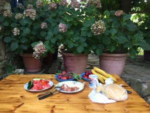 a table with plates of food and vegetables on it at Poraika studios in Raches +6 photos