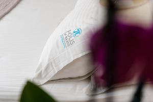 a close up of a pillow on a bed at Polis of Naxos Boutique Hotel in Naxos Chora