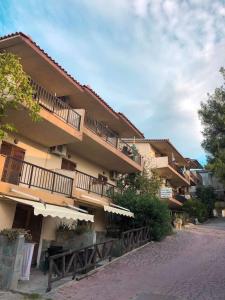 a building with balconies on the side of a street at Sarizas Apartments in Siviri