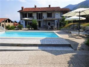 a villa with a swimming pool and a house at Holiday Home near Lago Maggiore Pool in Porto Valtravaglia