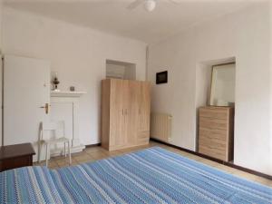 a bedroom with a bed and a dresser and a cabinet at Holiday Home near Lago Maggiore Pool in Porto Valtravaglia +32 photos