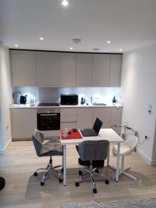 a kitchen with a table with a laptop on it at 23 floor studio for work 1Gb WiFi in Croydon