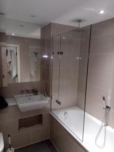 a bathroom with a shower and a sink at 23 floor studio for work 1Gb WiFi in Croydon