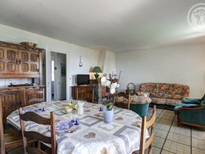 a living room with a table and a couch at Gîte Arçon (Loire), 3 pièces, 4 personnes - FR-1-496-177 in Arcon