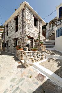 a large stone building with a building at Mirthia Apartments in Plakias