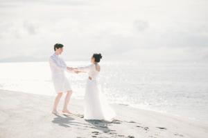Una novia y un novio de pie en la playa en Adang Island Resort, en Ko Lipe