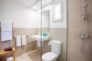 a bathroom with a shower and a toilet and a sink at Agulla park in Cala Ratjada