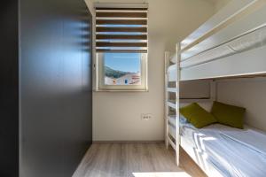 Postel nebo postele na pokoji v ubytování SUNRISE ISLAND LOFT