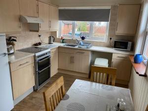 a kitchen with a sink and a stove top oven at Spacious first floor apartment in the centre of Church Stretton with free parking in Church Stretton