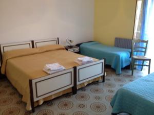 A bed or beds in a room at B&b La Scogliera