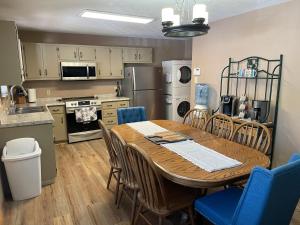 a kitchen and dining room with a table and chairs at Dear Love Cabin in Ruidoso