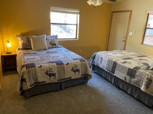 a bedroom with two beds and a window at Dear Love Cabin in Ruidoso