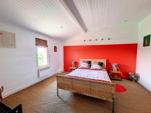 a bedroom with a red wall and a bed at Ferme de Mouline in Sainte-Foy-la-Longue +26 photos