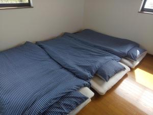 A bed or beds in a room at taiza house