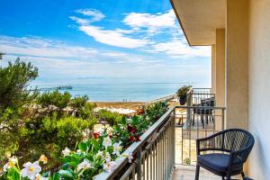 a balcony with a view of the beach at Hotel Petit Palais in Venice-Lido