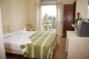Postel nebo postele na pokoji v ubytování Hotel B&B Risorta