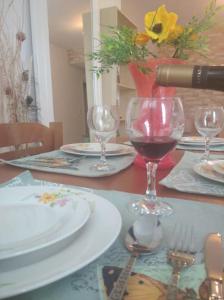a table with plates and glasses of wine on it at Igli apartments in Arkasa