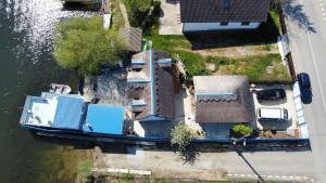 an overhead view of a house with a boat in the water at Wild Carp in Dunavăţu de Jos