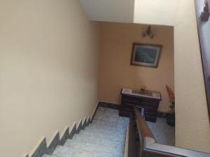 a room with a staircase with a bench and a desk at Casa Sopeña in Llanes