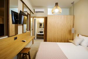 1 dormitorio con 1 cama y escritorio con TV en Fedra Plakias en Plakias