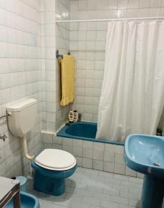 a bathroom with a toilet and a sink and a tub at Terraço do Lima in Ponte de Lima