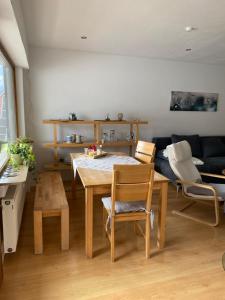 a living room with a table and chairs and a couch at Fewo Weinland in Zweibrücken