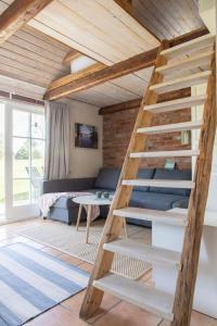 a loft bed with a ladder in a room at Lilla Paradiset in Tomelilla