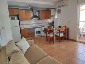 uma sala de estar com um sofá e uma cozinha com uma mesa em Paraiso Sol Lovely 1 bedroom in Torrox Costa em Torrox Costa