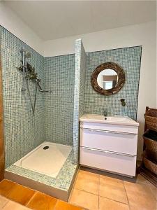 a bathroom with a shower and a sink and a mirror at CLOS DE LA BELLEVUE in Villes-sur-Auzon