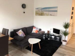 ein Wohnzimmer mit einem Sofa und einem Tisch in der Unterkunft FlatDeCologne VeeDel in Köln