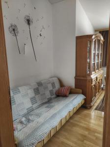 a living room with a couch and dandelions on the wall at Apartman Anita in Varaždin