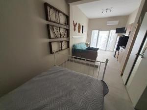 a bedroom with a bed and a living room at New apartment ,50m from the sea at Nea Irakleia. in Nea Irakleia