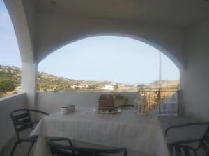 a table with a white table cloth on a balcony at CAMARES HOUSE in Agioi Apostoli