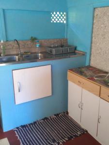 a kitchen with a sink and a counter top at Pension Te Nahetoetoe in Parea