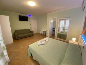 a living room with a bed and a couch at 103 Boutique Hotel Stintino in Stintino
