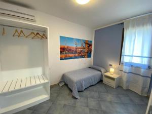 a small bedroom with a bed and a window at 103 Boutique Hotel Stintino in Stintino