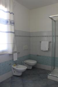 a bathroom with a toilet and a sink at 103 Boutique Hotel Stintino in Stintino