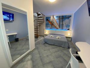 a bedroom with a bed and a staircase in a room at 103 Boutique Hotel Stintino in Stintino